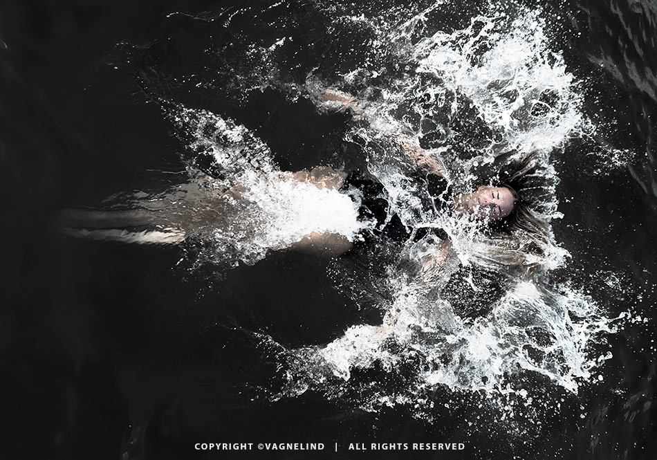 Cold water swimming in Sweden, photographed by Vagnelind for the book KALLA BAD, showing a woman entering icy water.